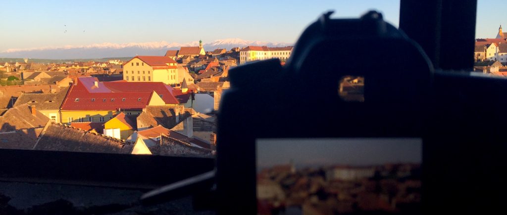 A view from an old school's attic in Sibiu - Fagaras mountains covered in snow in the background